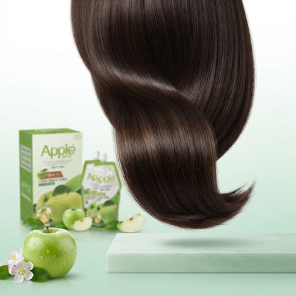 A large, glossy, dark brown hair extension or wig swirled in the air, with Apple Care packaging and a green apple displayed in the background on a light mint green surface.
Natural dark Apple Hair Color shade